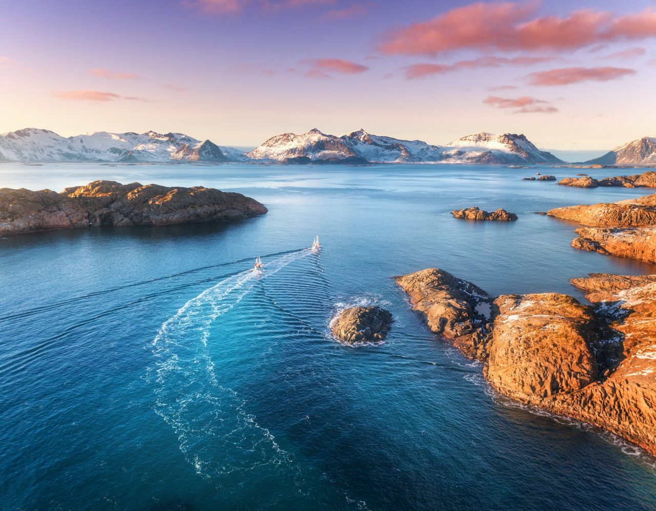 aerial-view-of-fishing-boats-rocks-in-the-blue-sea.jpg